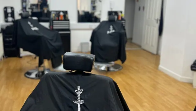 The branded capes at 121 Barber Therapy